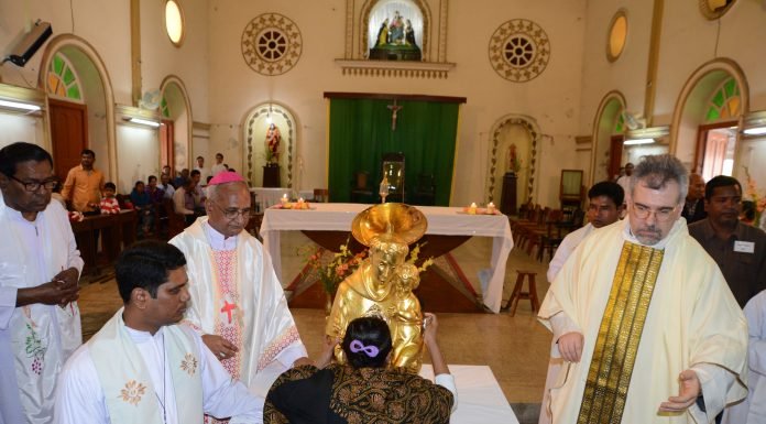 A pilgrim touching St. Anthony's Relic for Blessings