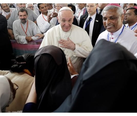 Pope Francis, is greeted by nuns as he arrives for a meeting with priests, men and women religious, seminarians and novices at the Church of the Holy Rosary, in Dhaka, Bangladesh - AP