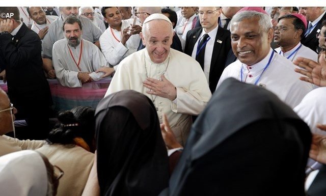 Pope Francis, is greeted by nuns as he arrives for a meeting with priests, men and women religious, seminarians and novices at the Church of the Holy Rosary, in Dhaka, Bangladesh - AP
